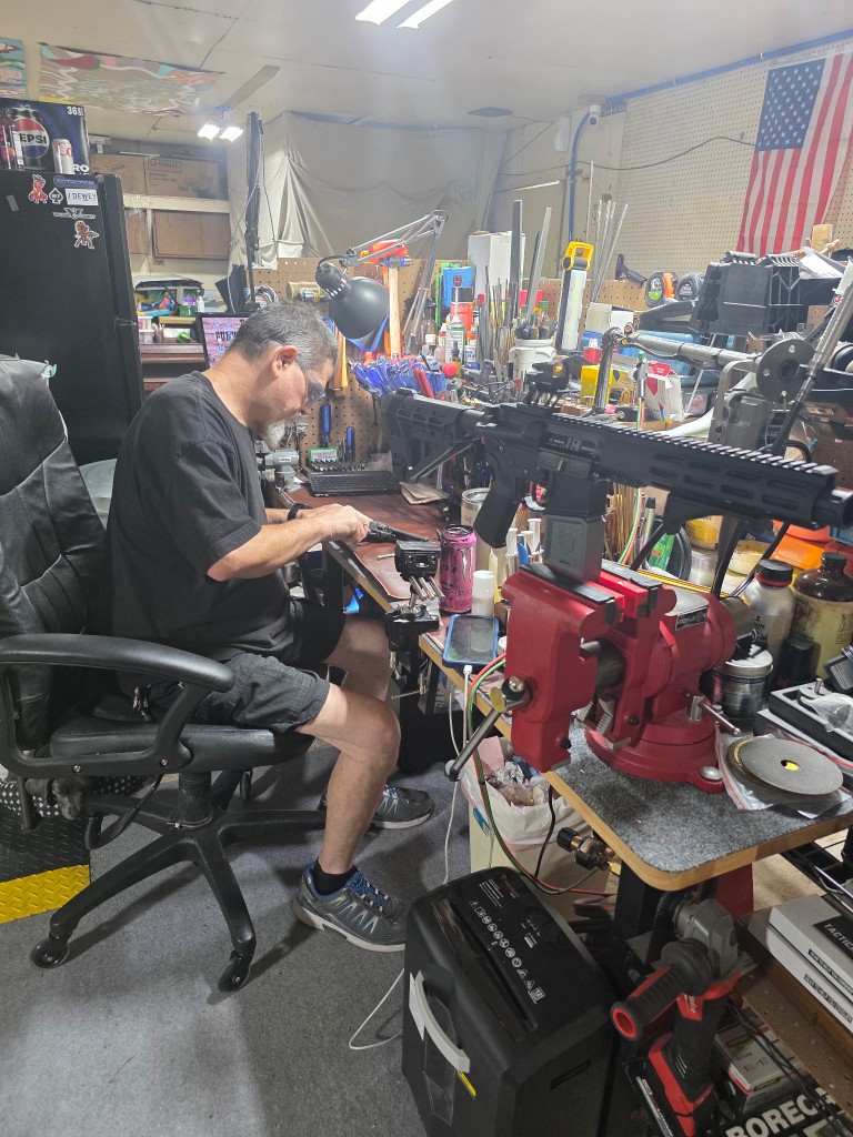 Dwayne Joiner at the workbench at Rockin D Gunworks